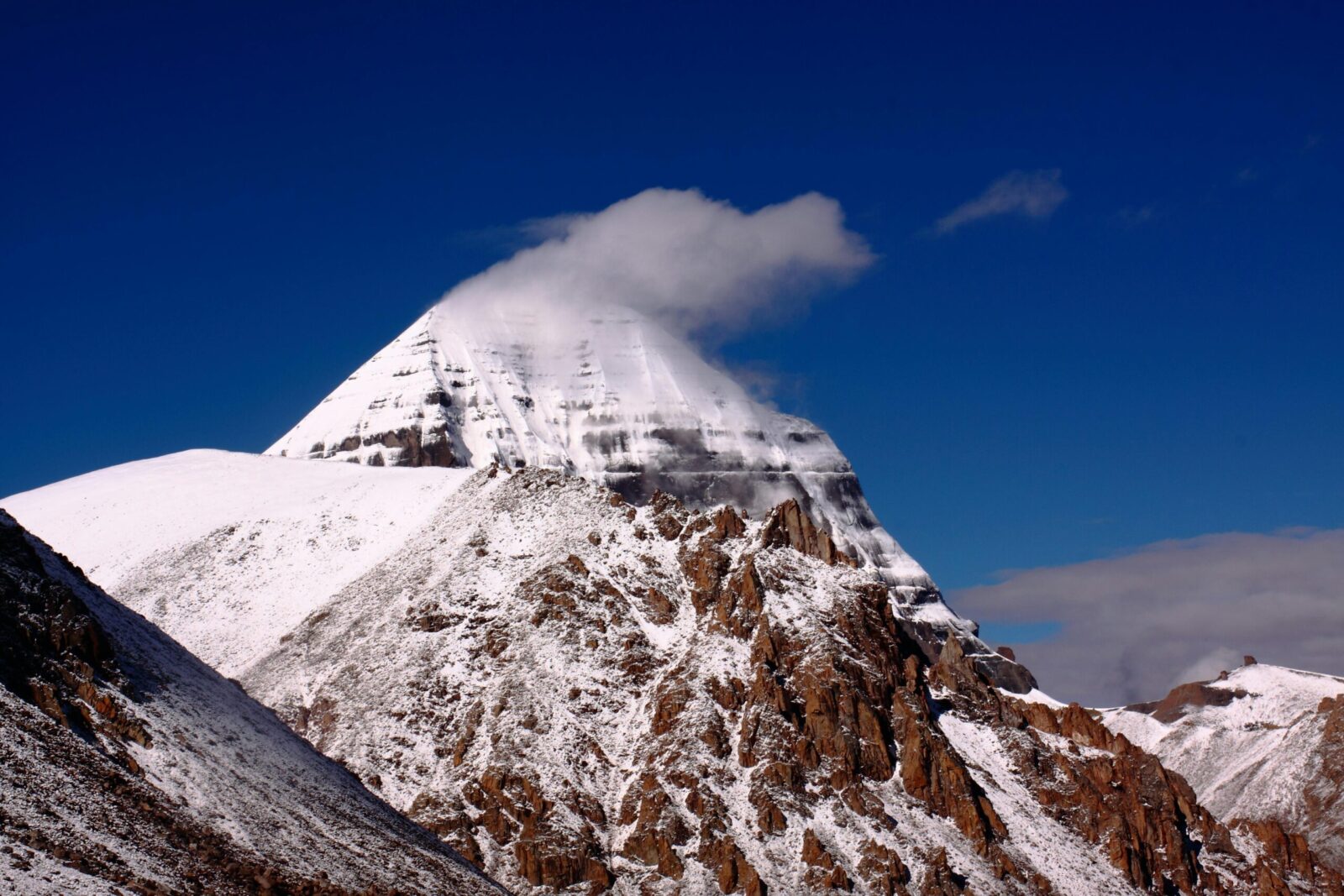 Breathtaking view of Mount Kailash in Tibet, covered in snow under a clear blue sky. Perfect for travel or nature themes.